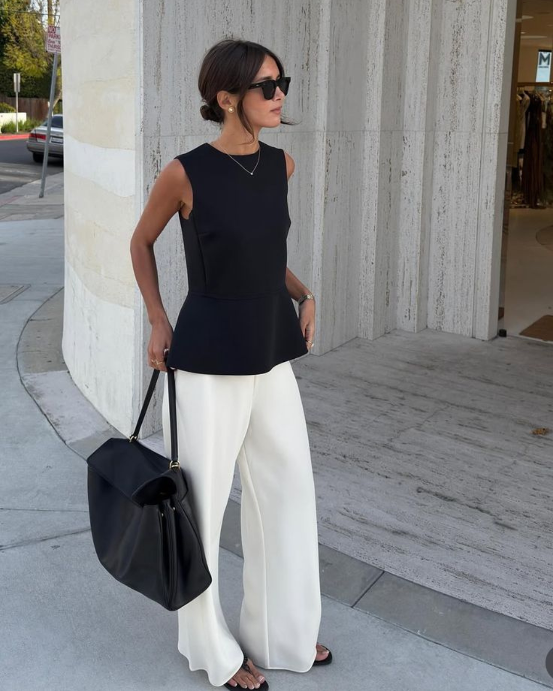 Warm weather vacation style with black sleeveless top and white wide leg trousers