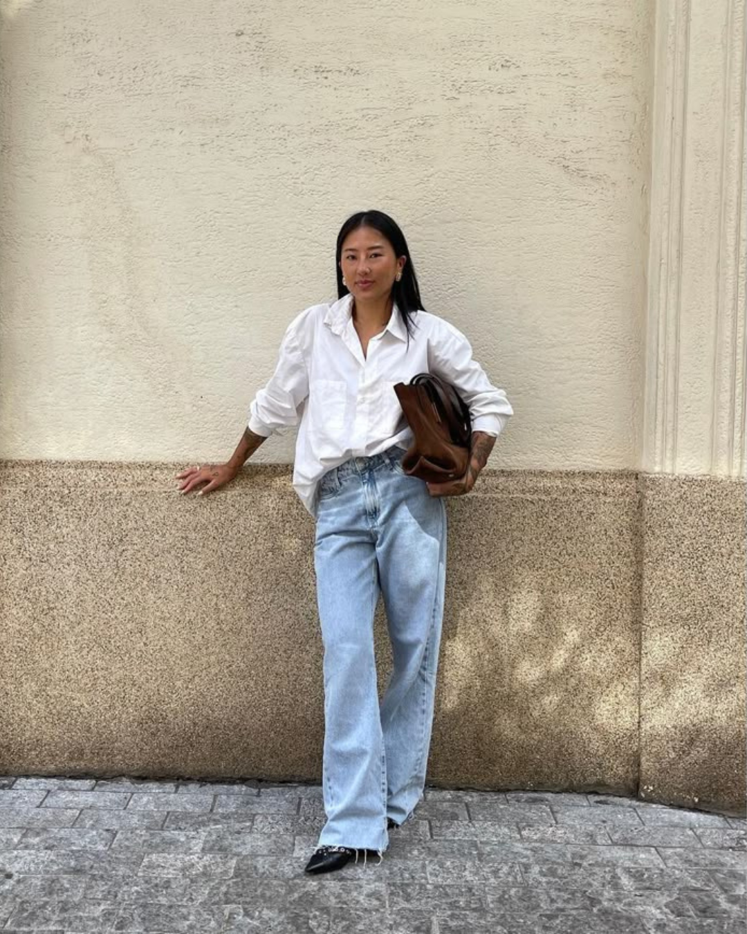 White button down shirt with french tuck style and light wash wide leg jeans
