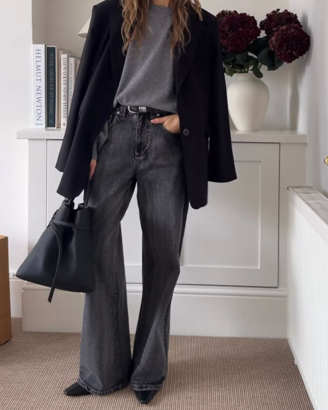 Chic workday look featuring black blazer grey top and dark wide leg jeans